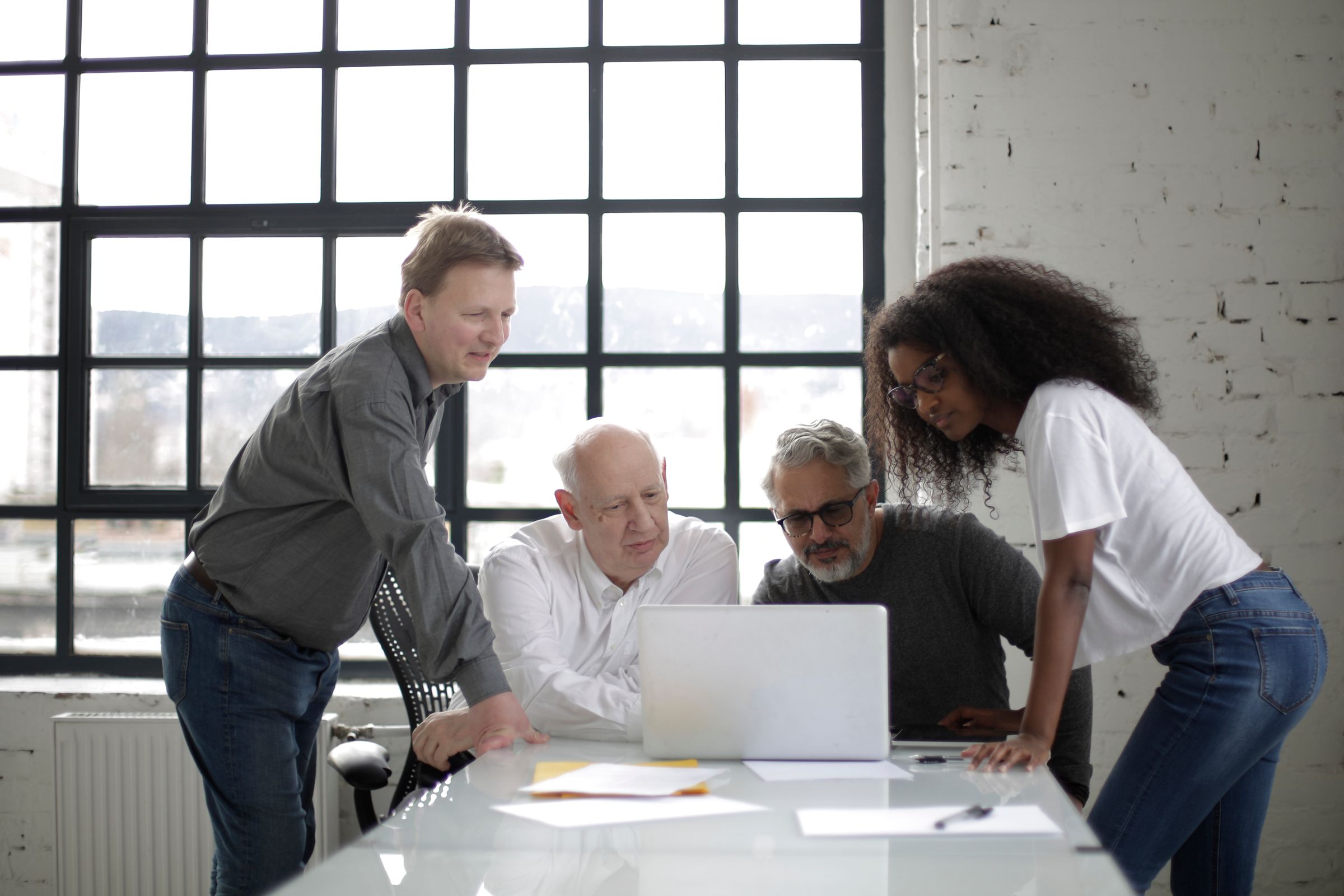 A multidisciplinary group collaborating around a computer